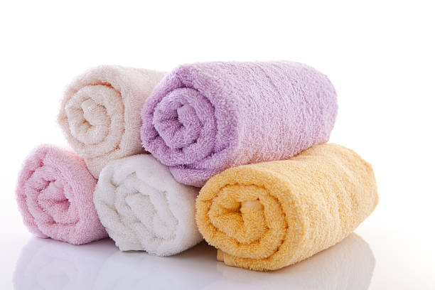 Rolled up bath towels on the white background.